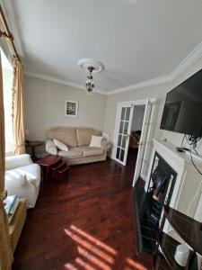 a living room with a couch and a fireplace at Annasrose cottage in Middlesbrough