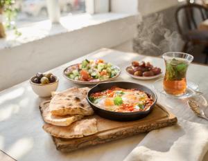 a table with a bowl of food and plates of food at Hilltop wood house #1 all-inclusive in Kaupanger