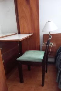 a chair with a desk and a lamp in a room at San Bernardo in San Bernardo