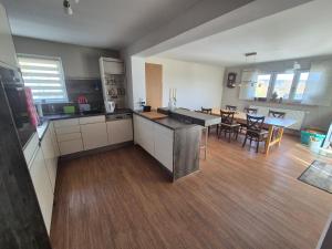 a large kitchen and dining room with a dining table at Zimmervermietung Müller in Kelheim