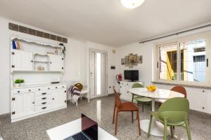 a kitchen with a table and chairs and a dining room at Appartamento La terrazza in Baunei