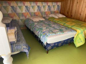 a bedroom with two beds and a colorful wall at La Faute Sur Mer in La Faute-sur-Mer