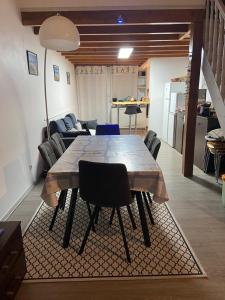 a dining table and chairs in a living room at La Faute Sur Mer in La Faute-sur-Mer