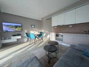 a living room with a couch and a table at BL Residence Balatonlelle in Balatonlelle