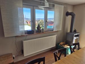 a room with a table and some windows and a heater at Zimmervermietung Müller in Kelheim +11 photos