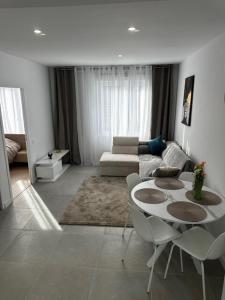 a living room with a table and a couch at Centre-ville de Saint-Brieuc in Saint-Brieuc