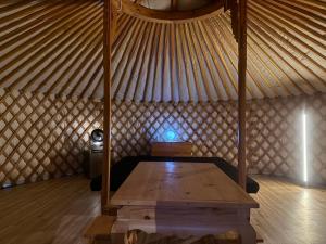 a room with a wooden table in a yurt at モンゴルゲルグランピング Frontier Village in Tōma +13 photos
