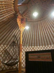 a room with a yurt with a sign and a basket at モンゴルゲルグランピング Frontier Village in Tōma