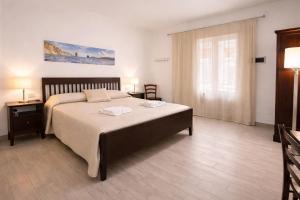 a bedroom with a large bed and a window at Holiday Home Tarinuzza in Lipari