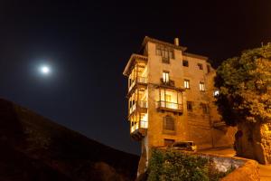 a building at night with the moon in the sky at Midama in Chillarón de Cuenca