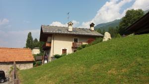 a house on the side of a green hill at Au Coeur in Verrayes
