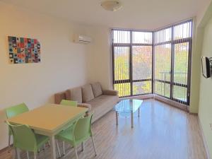 a living room with a couch and a table at Apartments in Relax Complex Fantasy in Hisarya