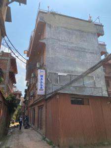 a building with a sign on the side of it at Hotel Malla Inn in Bhaktapur