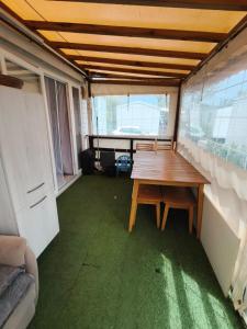 a room with a wooden table in the middle at Eucalyptus 24 du samedi au samedi location in Valras-Plage +9 photos