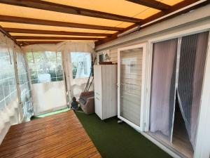 an inside view of a room with a porch and a door at Eucalyptus 24 du samedi au samedi location in Valras-Plage
