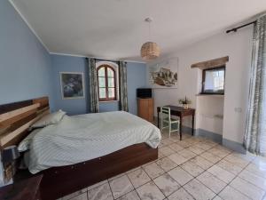 a bedroom with a bed and a desk in it at Piccolo Mondo in Perugia
