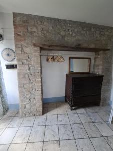 a room with a stone wall and a mirror at Piccolo Mondo in Perugia