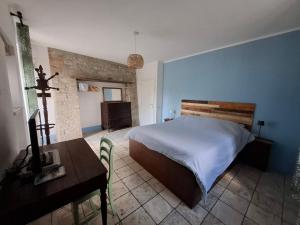 a bedroom with a bed and a table and a desk at Piccolo Mondo in Perugia