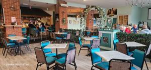 a restaurant with tables and chairs and a bar at Island Butterfly haven in Sandown