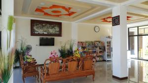 a store with chairs and a tv in a room at Charoensuk Grand Hotel in Kabin Buri