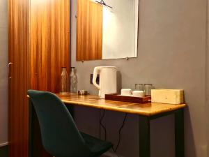 a room with a table with a chair and a counter with aounter at Mayuri Lodge in Kalimpong