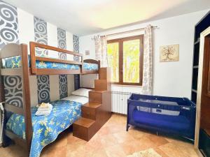 a bedroom with bunk beds and a blue bed at La Cinisara in Carini