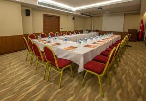una mesa larga en una habitación con sillas rojas en Innova Sultanahmet Istanbul, en Estambul