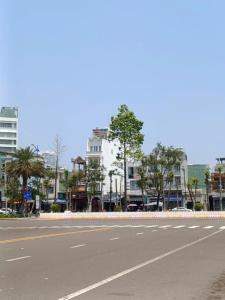 an empty street in a city with buildings at Queen-Hotel in Quy Nhon