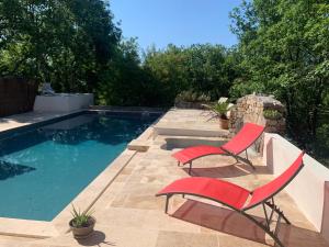 a patio with two chairs and a swimming pool at Chambre d'hôtes avec climatisation, terrasse privée et accès piscine in Saint Alban Auriolles