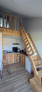 a kitchen with a wooden staircase in a room at La Maison de Pandora in Maulévrier +6 photos