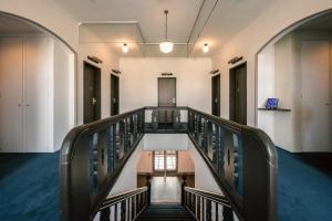 a hallway with a staircase in a building at T9 Hakodate in Hakodate