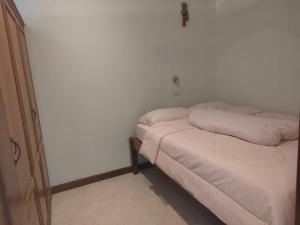 a bed with two pillows on it in a room at View Talay 3 Apartment in Pattaya South +5 photos