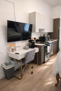 a kitchen with a desk in the middle of it at Cozy Studio Downtown Detroit in Detroit