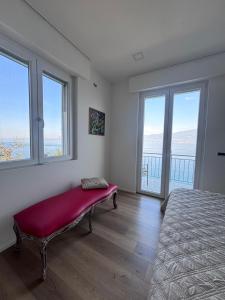 a bedroom with a bed with a red bench in it at CasaPi' in Torri del Benaco