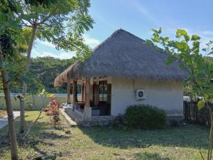 a small house with a thatched roof at Melody Surf Ekas Lombok in Ekas +43 photos