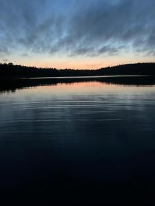 a large body of water with a sunset in the background at Sommartornsgård in Munkedal