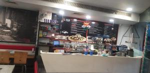a fast food restaurant with a counter in a room at hotel neelkamal in Ajmer