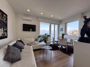 a living room with a white couch and a table at CasaPi' in Torri del Benaco
