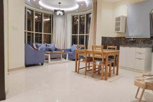 a kitchen and living room with a table and chairs at شقق سما الرفاع للشقق المخدومة in Al Kharj +82 photos