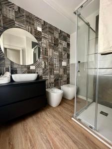 a bathroom with a shower and a sink and a mirror at Blu Opèra Guest Rooms in Soverato Marina +35 photos