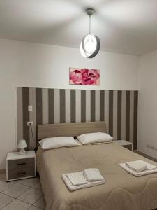 a bedroom with a bed with two towels on it at Affittacamere Rosy in Foligno