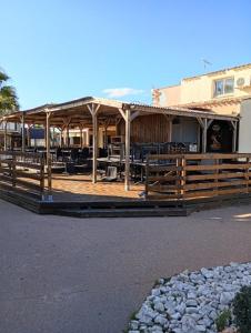 a building with a wooden fence in front of it at Mobile-Home L'Instant Marin in Sérignan