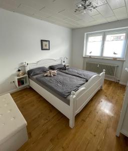 a bedroom with a bed with two shoes on it at Frisch saniertes Apartment am Falderapark in Neumünster