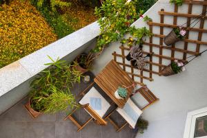 an overhead view of a table and bench with potted plants at Charming Apartment in Zagreb