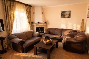 a living room with two couches and a fireplace at Villa del Mare in Dobra Voda +36 photos
