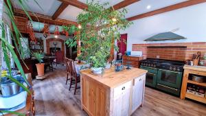 a kitchen with a wooden island with a tree in it at Dom Pod Złotym Bażantem in Kobiela +35 photos