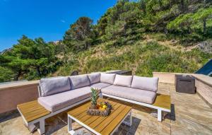a couch sitting on a patio with a table at Vistamar in Canyamel