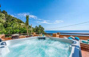 a hot tub with the ocean in the background at Vistamar in Canyamel +44 photos