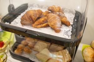 a container filled with croissants and other pastries at Masseria Coccolo in Carovigno +18 photos