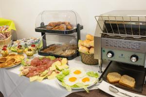 a table with a buffet of food and an egg and bread at Masseria Coccolo in Carovigno